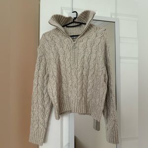 Cream colored knit quarter zip sweater